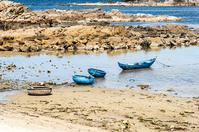 Boats in sea shore at beach