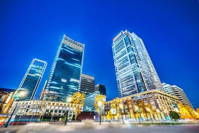 Low angle view of illuminated building against blue sky