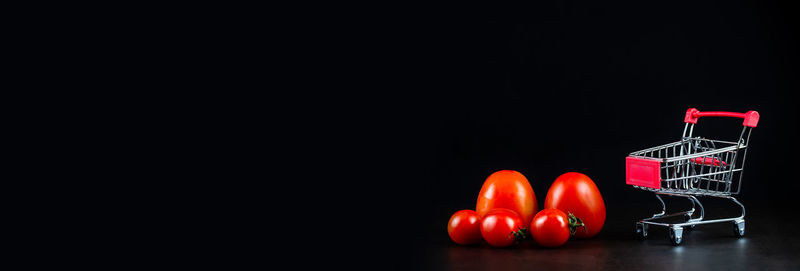 Close-up of red bell against black background