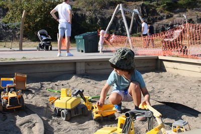 Portrait of boy playing with toy car