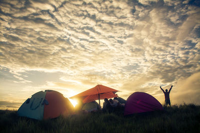 Tent on field against sky during sunset