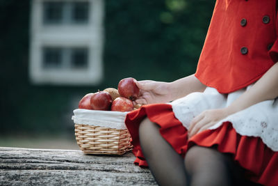 Midsection of woman holding ice cream in basket