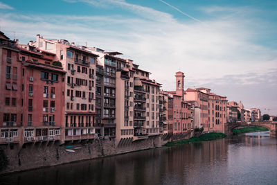 Italian buildings over a river on a sunny day in florence