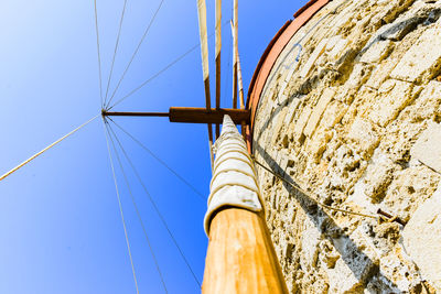 Low angle view of sailboat against clear blue sky