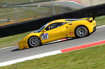 Blurred motion of yellow car on road