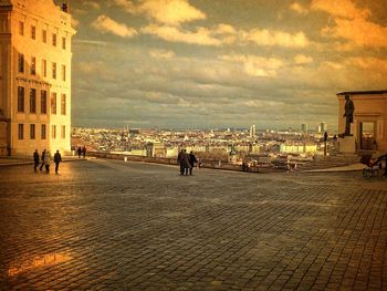 Buildings against cloudy sky