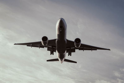 Low angle view of airplane flying in sky