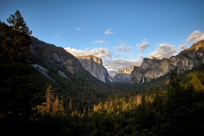 Scenic view of mountains against blue sky