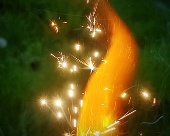 Low angle view of firework display at night