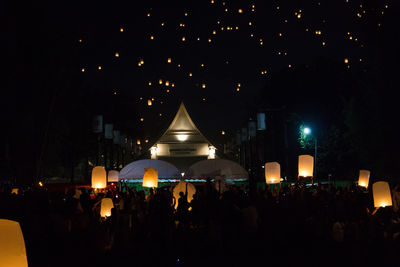 Group of people in illuminated building at night