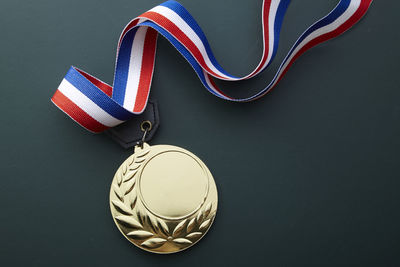Close-up of gold medal against black background