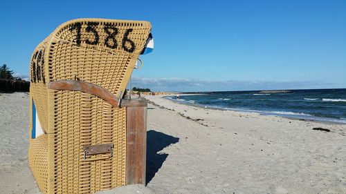 Lifeguard hut on beach against clear sky