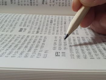 Cropped hand writing in book