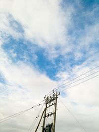 Low angle view of electricity pylon against sky