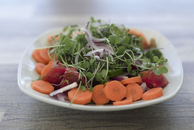 Close-up of chopped fruits in bowl on table