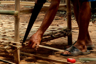 Low section of men standing on metal