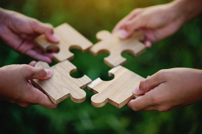 Cropped hand of man holding jigsaw piece