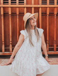 Young woman portrait smiling in white dress with a rustic door background from puerto rico san juan