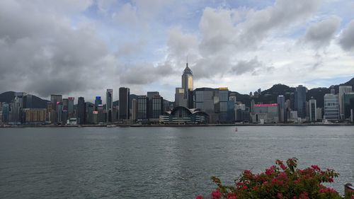 Panoramic view of bay and buildings against sky