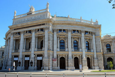 Low angle view of historical theatre building against sky