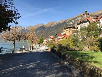 Town by buildings in city against sky