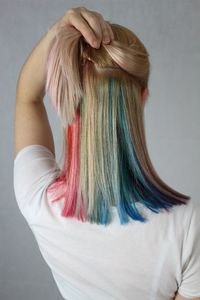 Rear view of woman with dyed hair against gray background