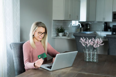 Woman using mobile phone at home