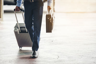 Low section of woman walking on floor