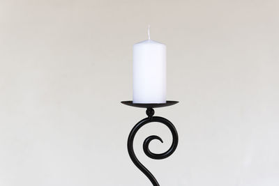 Close-up of candlestick holder against white background