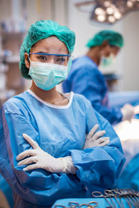 Portrait of doctor with arms crossed standing in operating room 