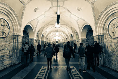 Rear view of people walking in corridor