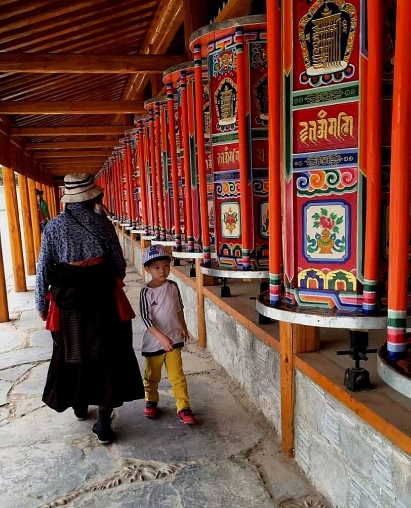 FULL LENGTH REAR VIEW OF A MAN WALKING IN A TEMPLE