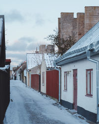 Street amidst houses against sky