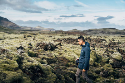 Photographer hiking through rough terrain in iceland