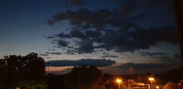 Low angle view of silhouette trees against sky at night