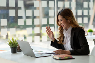 Businesswoman using laptop on table