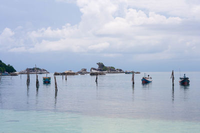 Boats in sea against sky