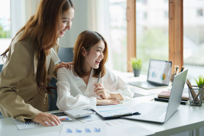 Smiling businesswomen talking on video conference