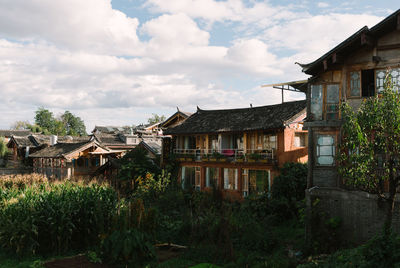 Houses on field against sky