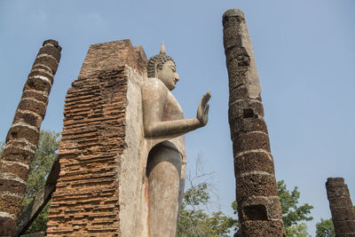 Low angle view of statue of temple against sky