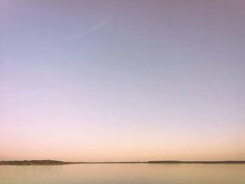 Scenic view of sea against clear sky during sunset