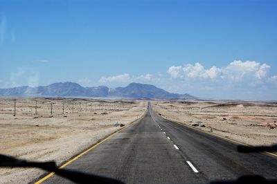 Country road leading towards mountains