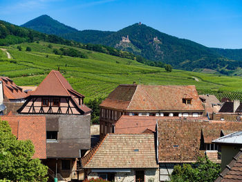 Houses on mountain against sky