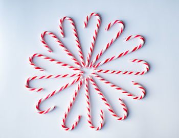 Candy canes arranged in a circle on a plain white background.