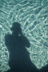 Shadow of person in pool water