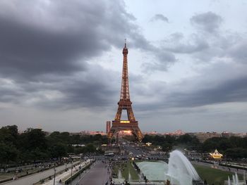 Communications tower against cloudy sky