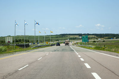 Vehicles on road against sky