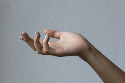 Close-up of person hand against white background