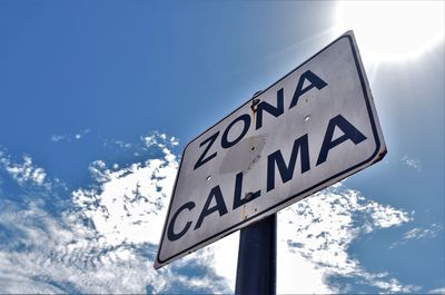 Low angle view of road sign against sky