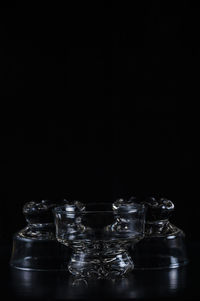 Close-up of glass bowls against black background